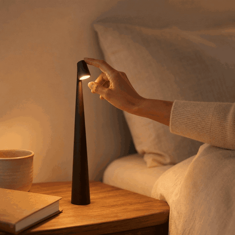Hand switches on the LumiNord cordless LED table lamp by touch and selects the brightness