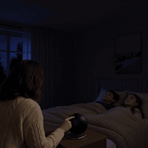Mother switches on the CosmoLight galaxy star projector for her kids