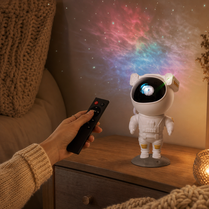 Hand controls the Astronaut star projector with the remote control