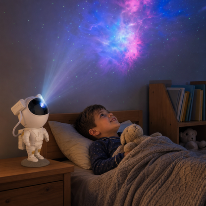 Boy in bed looking excitedly at the starry sky of the Astronaut projector, sleep aid for the kids room