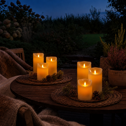 Cordless LED candles glowing on the garden terrace at dusk