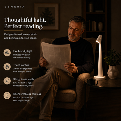 Man reading the newspaper next to the white NordicEleganz lamp, eye friendly light with 3 brightness levels
