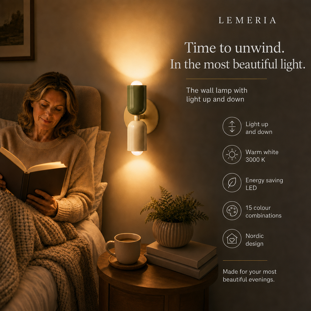 Woman reading in bed next to the Orion LED wall light with light up and down, warm white 3000 K