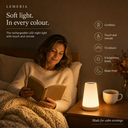 Woman reading in bed next to the LumiMood touch night light with remote, 13 colours and sleep timer