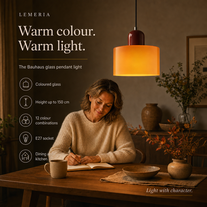Woman writing at the dining table under the Colora coloured glass pendant light