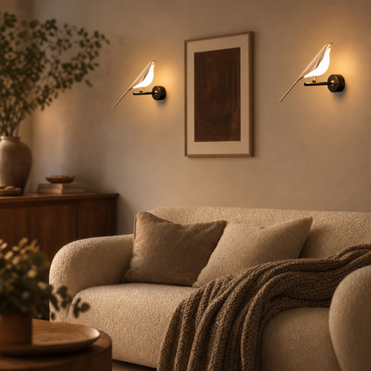 Two Avia gold bird wall lights above the sofa in the living room
